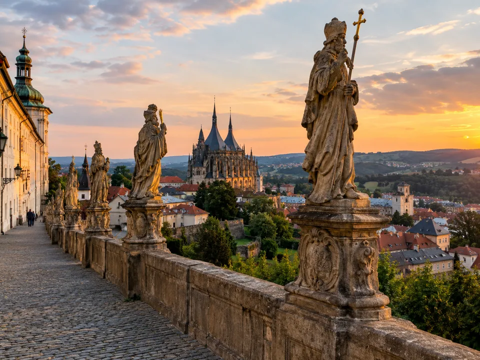 Baroque stone statues of saints along a balustrade above the town