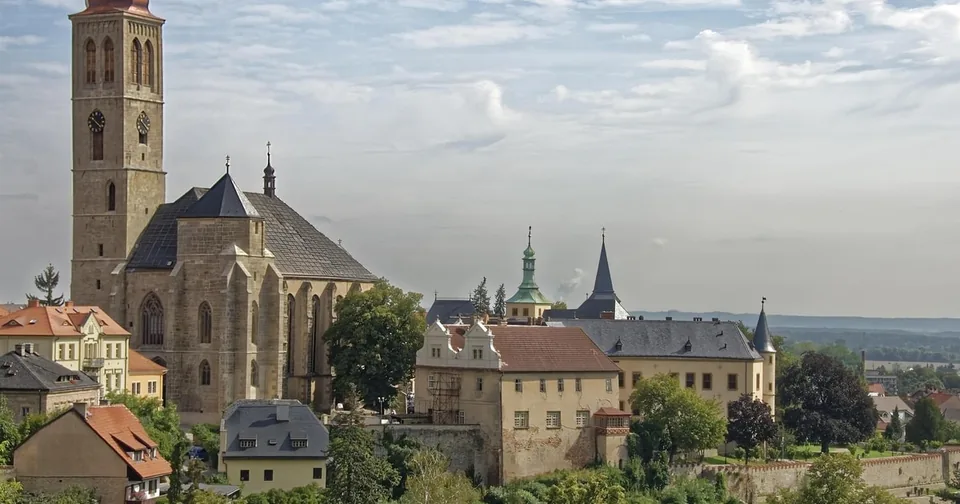 A Gothic church tower above the roofs of an old town